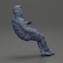 Man Sitting Wearing a Puffer Jacket, Holding a Coffee Cup - Only-Games