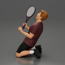 tennis player holding racket sits in celebration of his victory - Only-Games