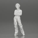 A chola girl with curly hair standing in large pants with crossed hands - Only-Games