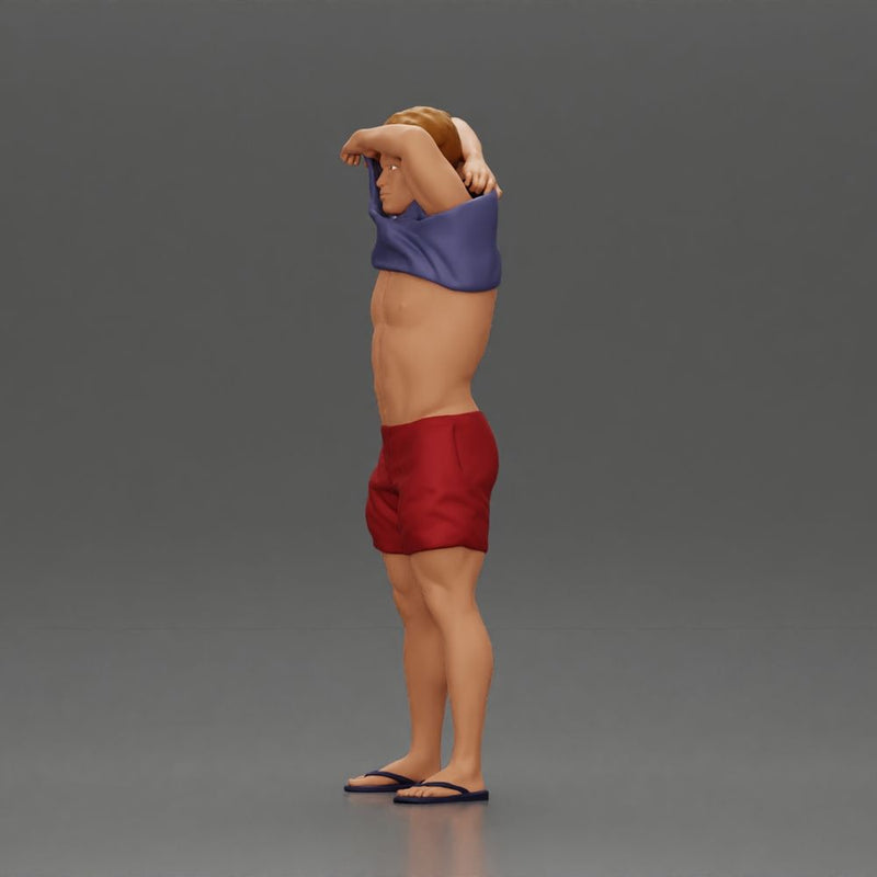 muscular man in shorts taking off his shirt to go swimming - Only-Games