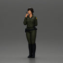 policewoman standing hand resting on her back speaking into a radio with short hair - Only-Games