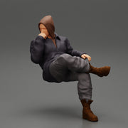 man in leather jacket and jeans sitting cross legged and thinking - Only-Games