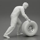 Mechanic worker walking and rolling tyre - Only-Games