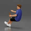 Man in shorts sitting explaining and holding a drink - Only-Games