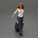 2 Business woman in shirt and trousers pulling suitcase walking in airport terminal - Only-Games