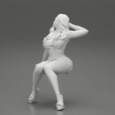 Young sexy girl in shorts with long hair is sitting with one hand in hair - Only-Games