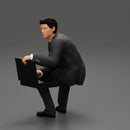 businessman sitting and holding briefcase of money - Only-Games