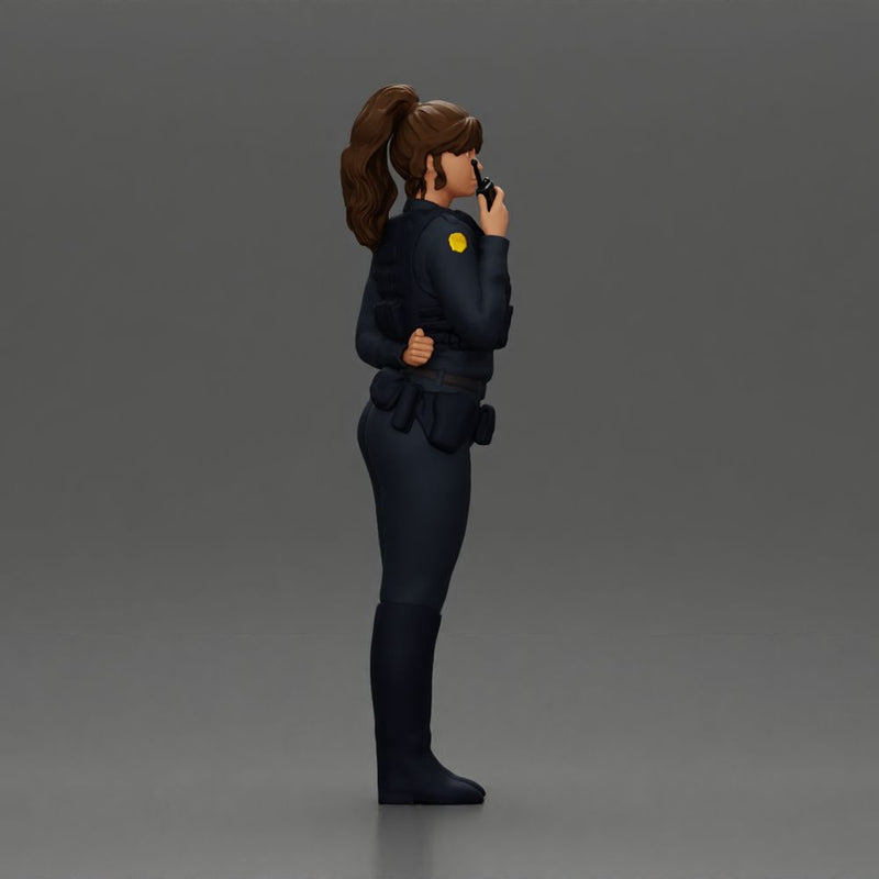 policewoman standing hand resting on her back speaking into a radio