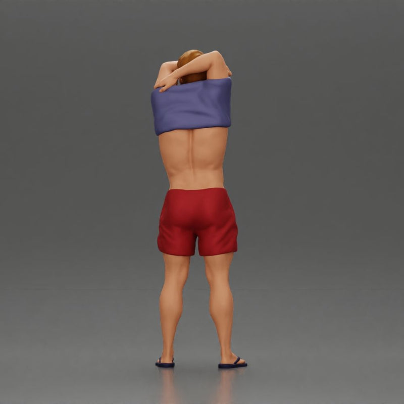 muscular man in shorts taking off his shirt to go swimming - Only-Games
