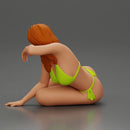 attractive girl in a bikini, lying and reclining gracefully on the beach - Only-Games