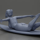 surfer girl with effortless grace, lying on her surfboard as she rides the wave - Only-Games