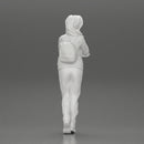 young woman listening to music with headphones and carrying a backpack - Only-Games