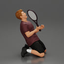 tennis player holding racket sits in celebration of his victory - Only-Games