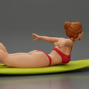 surfer girl with effortless grace, lying on her surfboard as she rides the wave - Only-Games