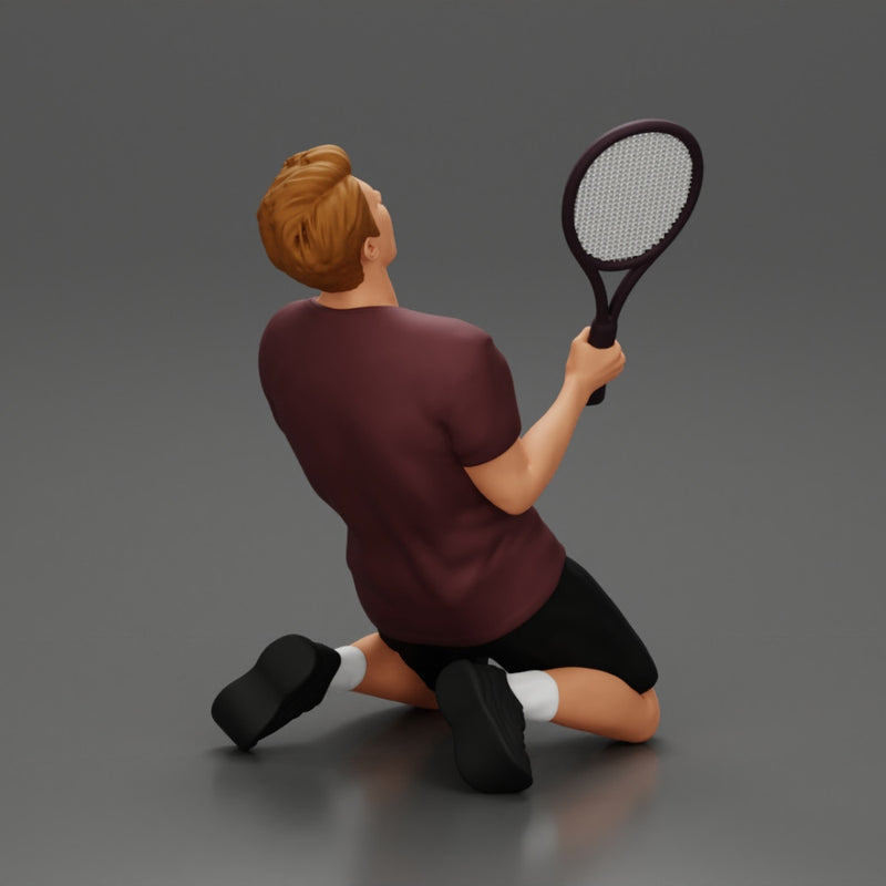 tennis player holding racket sits in celebration of his victory