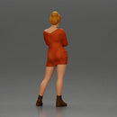 Woman in Orange Dress and Boots Stands Stylishly Confidence With Arms Crossed - Only-Games