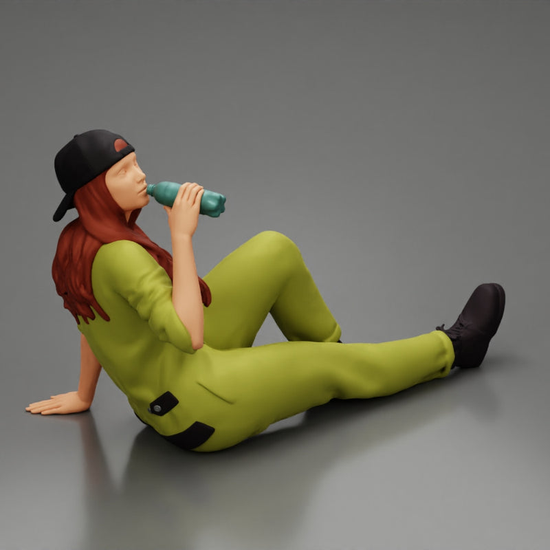 Tired woman mechanic in suit and backwards cap sitting and drinking water during from bottle - Only-Games