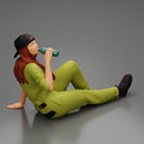Tired woman mechanic in suit and backwards cap sitting and drinking water during from bottle - Only-Games