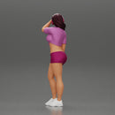 young woman in shorts and headphones shields her eyes from the sunlight - Only-Games