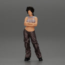 A chola girl with curly hair standing in large pants with crossed hands - Only-Games