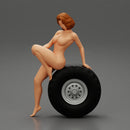 Sexy naked girl sitting on a truck tyre - Only-Games