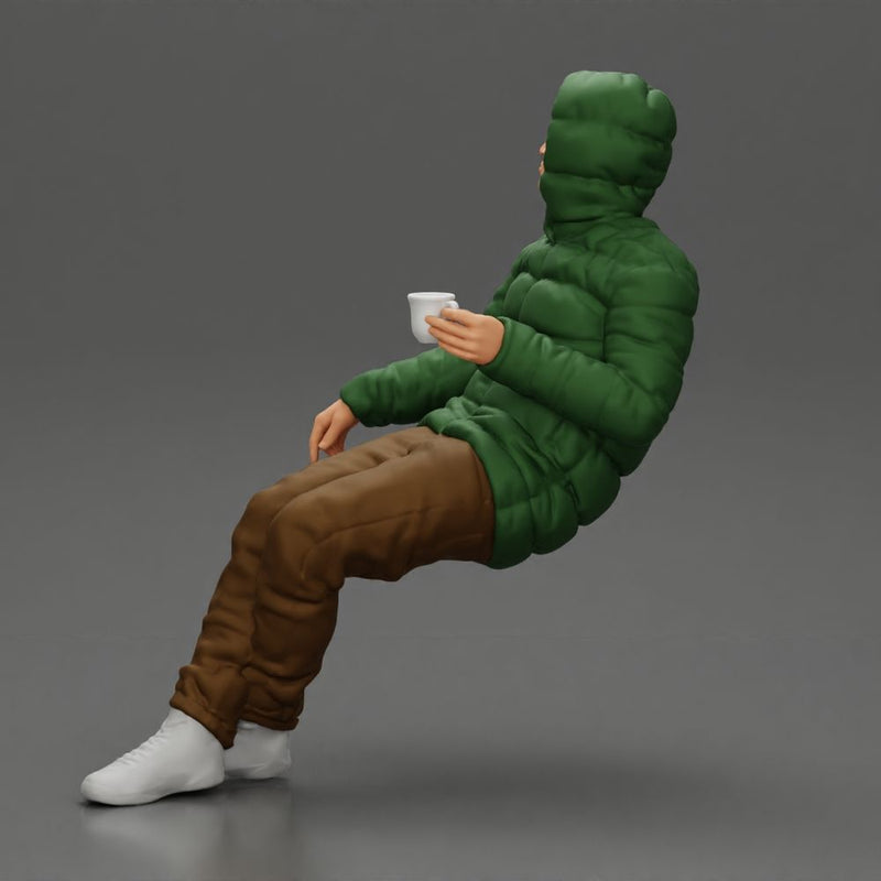 Man Sitting Wearing a Puffer Jacket, Holding a Coffee Cup