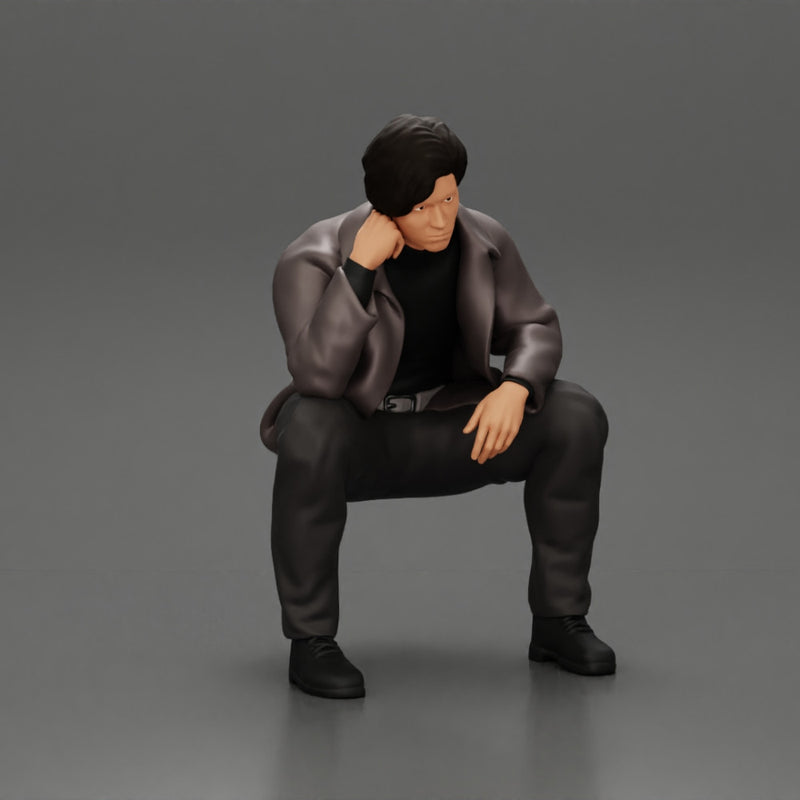 Worried man in a leather jacket sitting and thinking