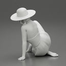 young woman in a summer suit and hat sitting - Only-Games