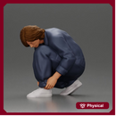 Worker injumpsuit Squatting Down, Carefully Adjusting His Pants with Focus