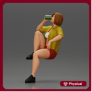 Young woman sitting on a chair hugging her pulled-up leg while drinking