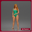 Woman stands barefoot wearing one piece swimsuit smiling relaxed at beach