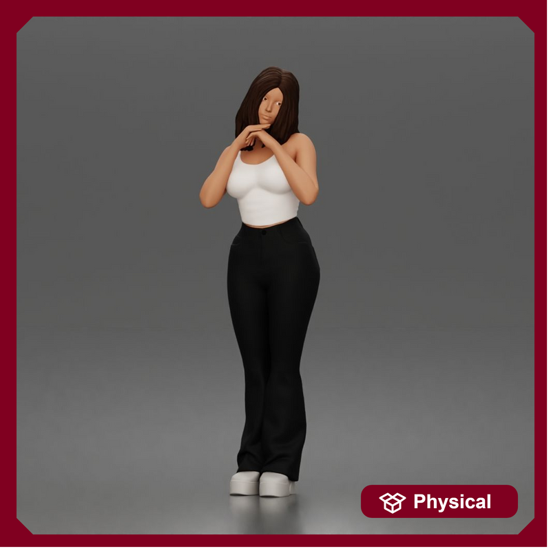 Thoughtful woman stands daydreaming wearing crop tank top and trousers