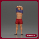 muscular man in shorts taking off his shirt to go swimming