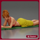 Relaxing on a beach towel, a woman enjoys sunbathing, wrapped in a pareo beach cover and bikini
