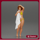Sexy girl in bikini standing and covering her body by towel