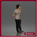 Relaxed young man in beanie standing casually with hands behind back thinking