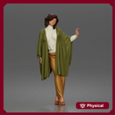 Woman gestures gracefully wearing flowing cape turtleneck sweater tailored trousers platform heels