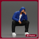 Thoughtful Man in Hoodie Squatting with Hand on His Face