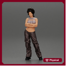 A chola girl with curly hair standing in large pants with crossed hands