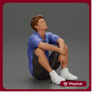 man sitting in shorts on the floor with hands on his knees