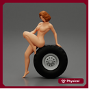 Sexy naked girl sitting on a truck tyre