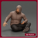 Contemplative man in hoodie sitting cross-legged, expressing curiosity thoughtfully