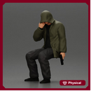 Man in hooded jacket sits alone holding gun feeling troubled