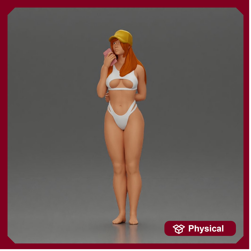 girl in a white bikini holding a phone on the beach and wearing a cap