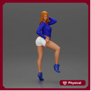 Woman in blue top and white shorts posing on a motorbike