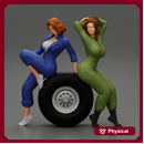 Two sexy girls in mechanic suits are sitting on a truck tire